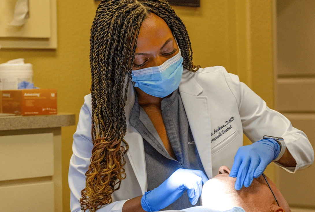dentist is checking up the patient at the dentist office Our Best Dentist Diagnoses the adult in clinic at very affordable Price at our dental office Sherman TX
